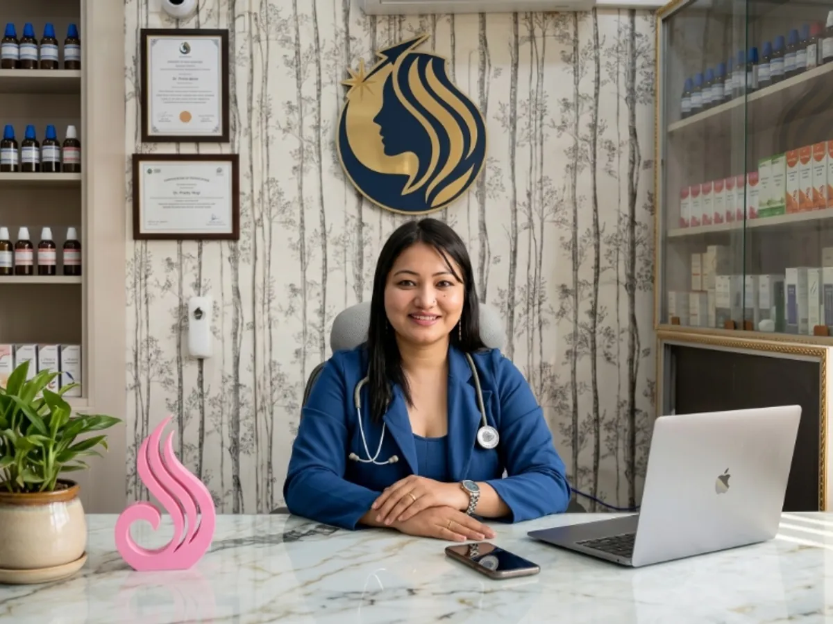 Dr. Preity Negi at her homeopathy clinic desk with natural remedies and medicines